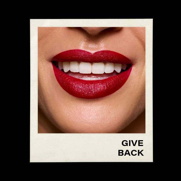 Close-up of a person's lips with red lipstick and a 'Give Back' text on a black background